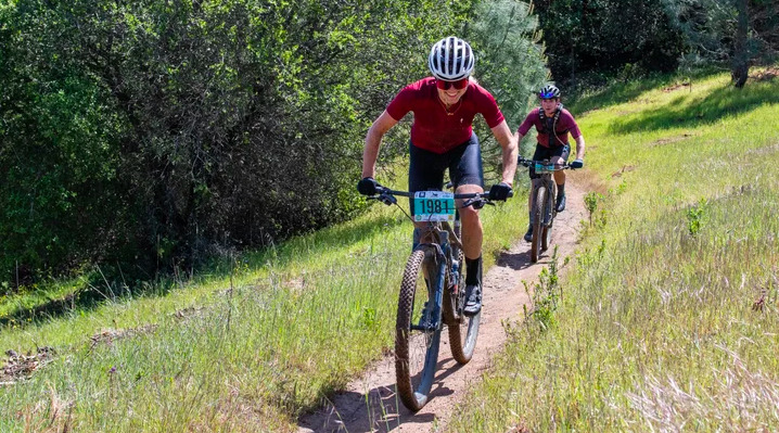 Mountain bikers racing on a trail.