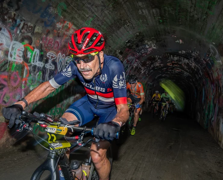 gravel cyclist riding through tunnel at tryon gravel gallop