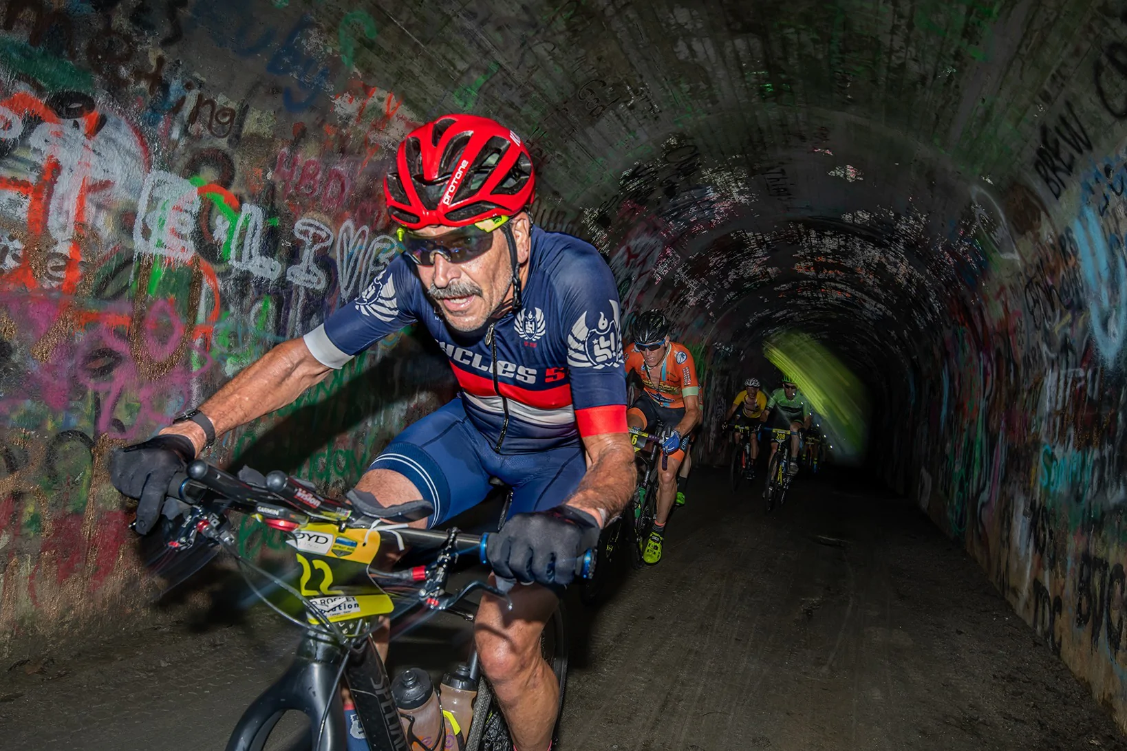 gravel cyclist riding through tunnel at tryon gravel gallop