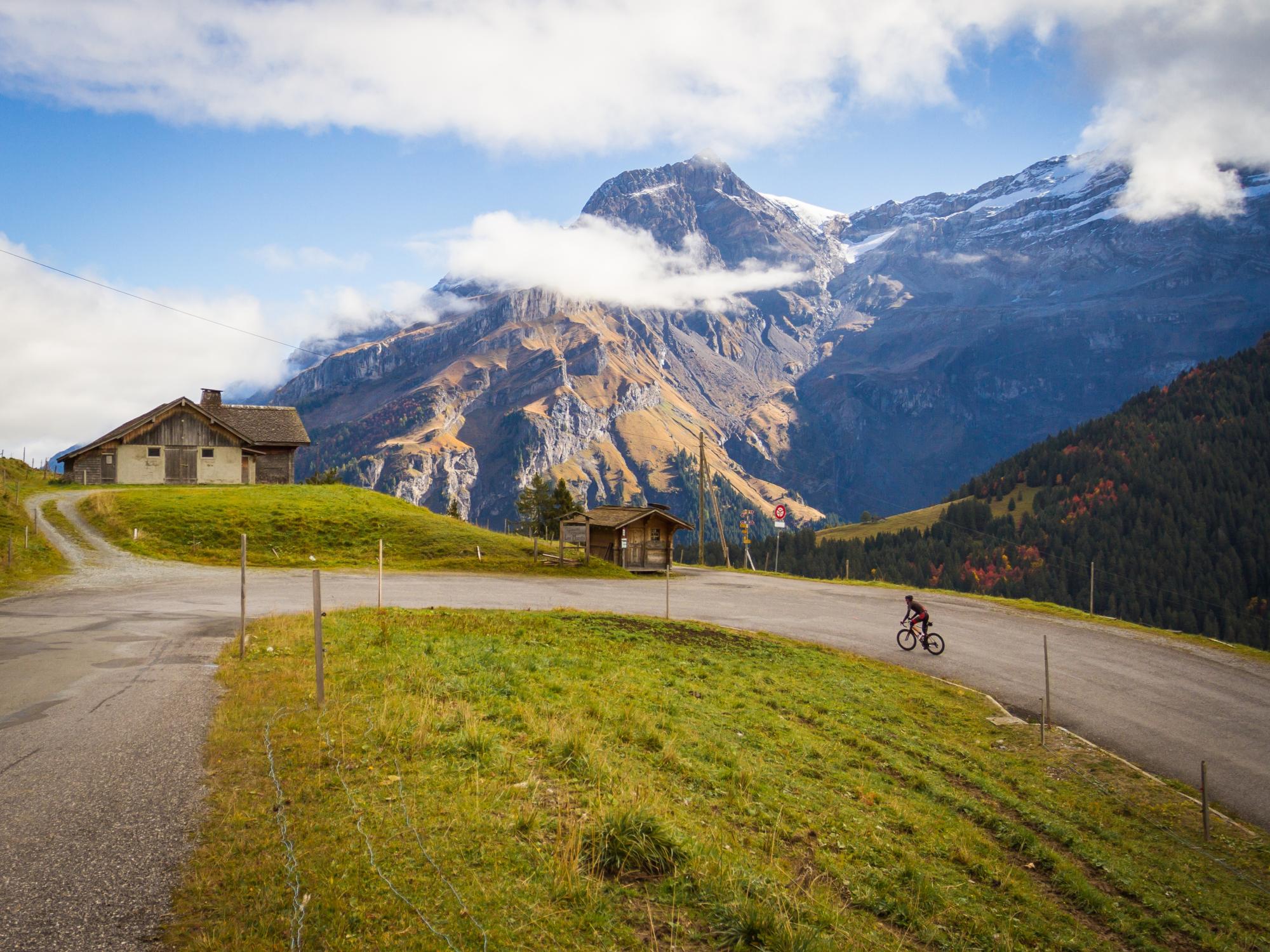Rider on a climb with Swiss Alp backdrop