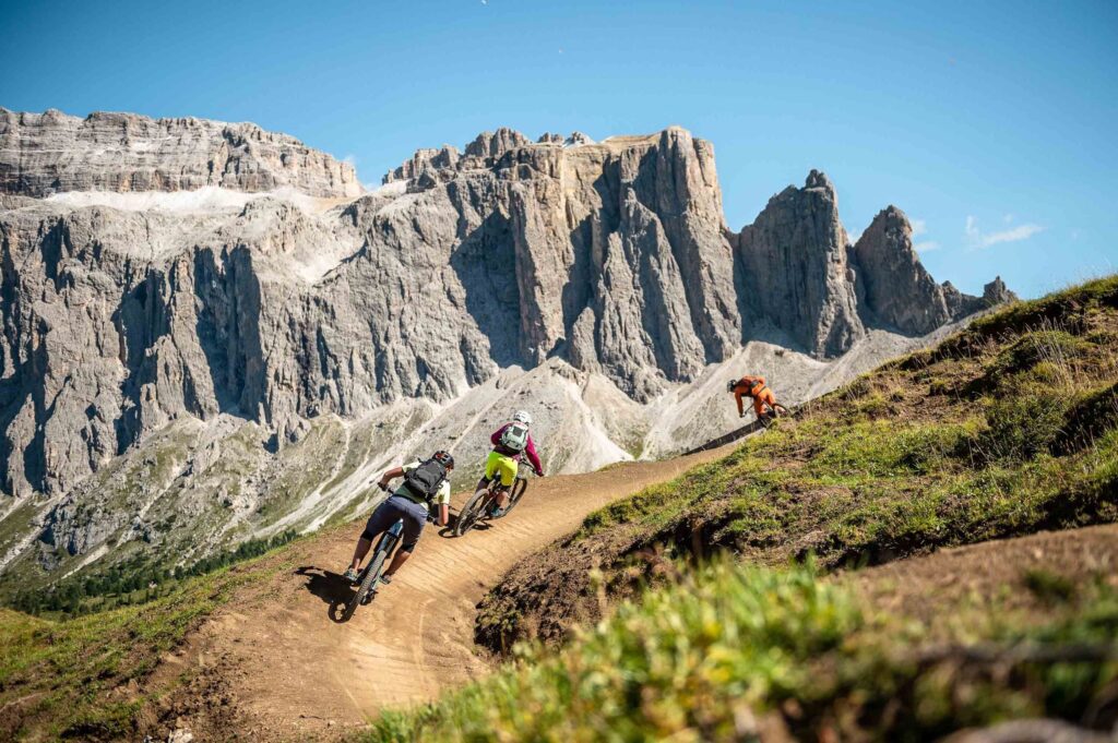 Riders on descent in Dolomites