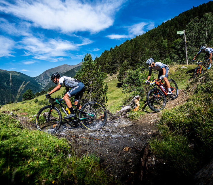 Riders navigating a stream on Andorra Epic Trail