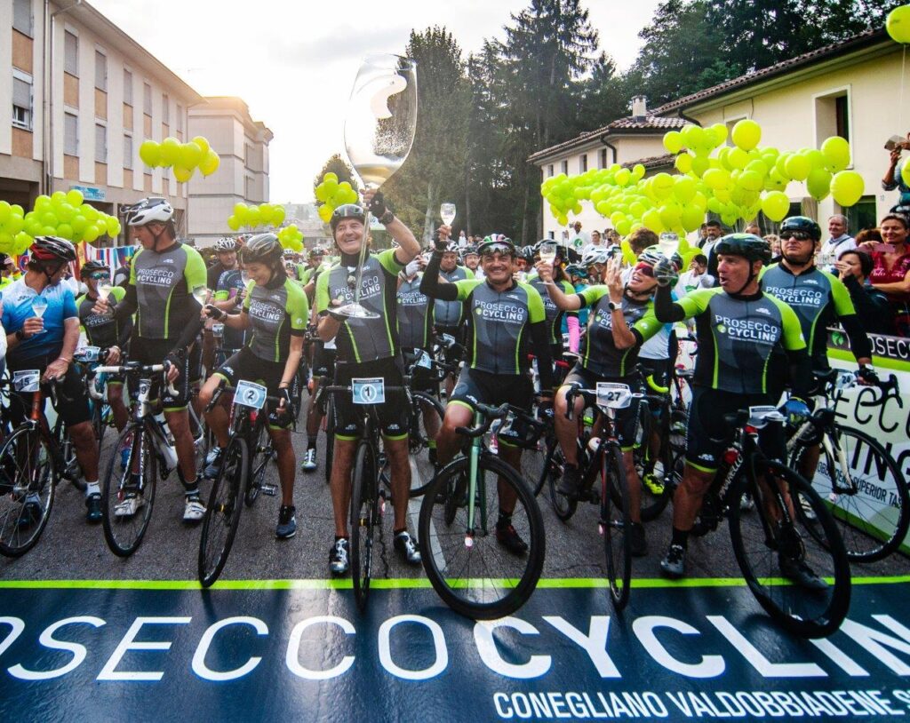 PRO19_b_Il-brindisi-di-Giancarlo-Moretti-Polegato Riders drinking Prosecco at start of Prosecco Gran Fondo