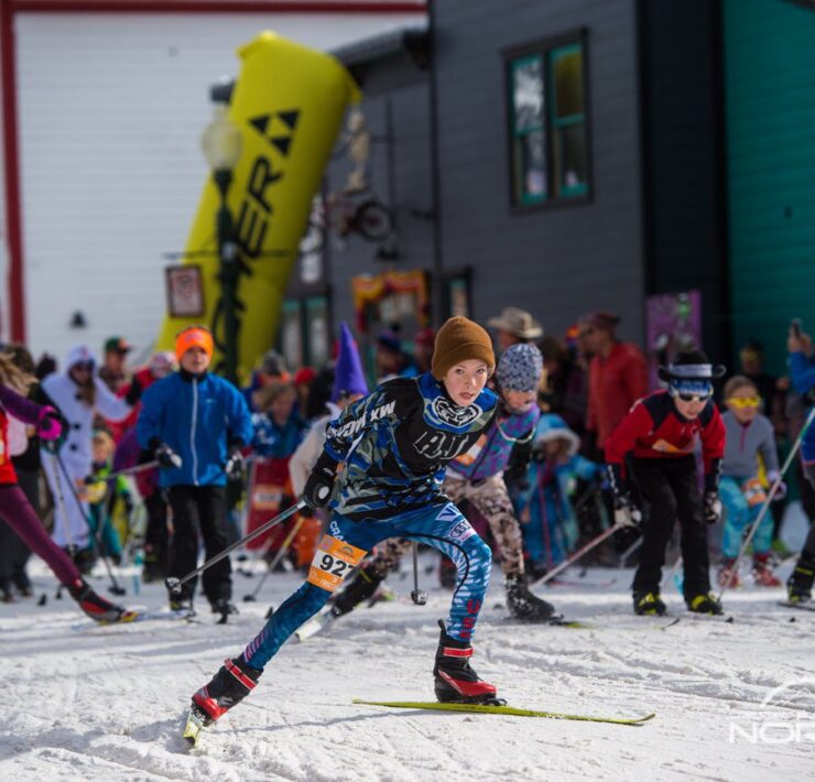Picture of racers on course through Crested Butte town from the sidelines