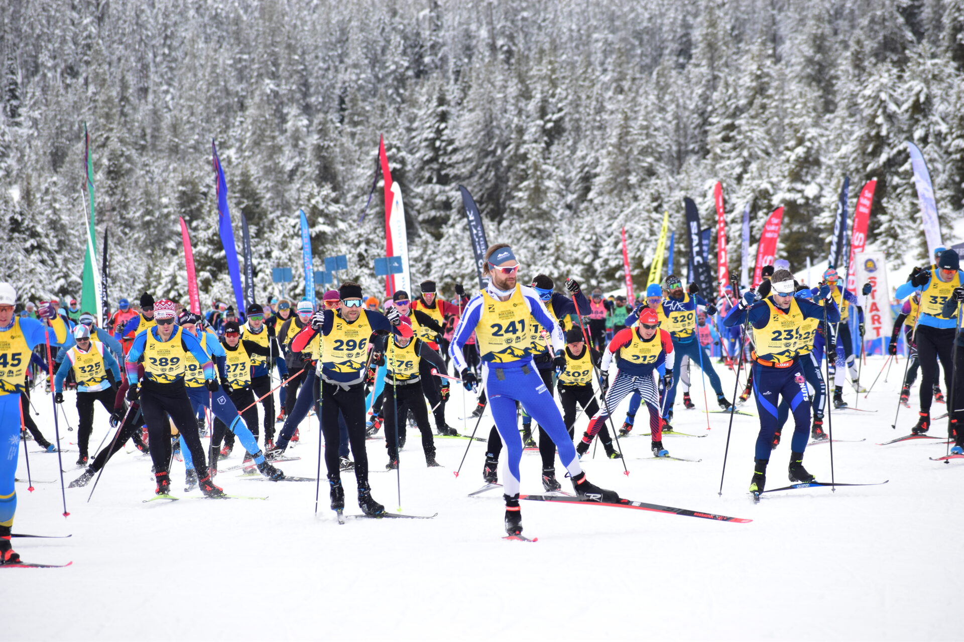 Sideline view of BMT racers in yellow wave of race