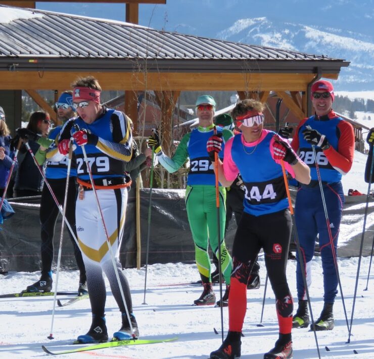 Close-up candid image of seven skiers preparing for the Snow Mountain Ranch Stampede starting line