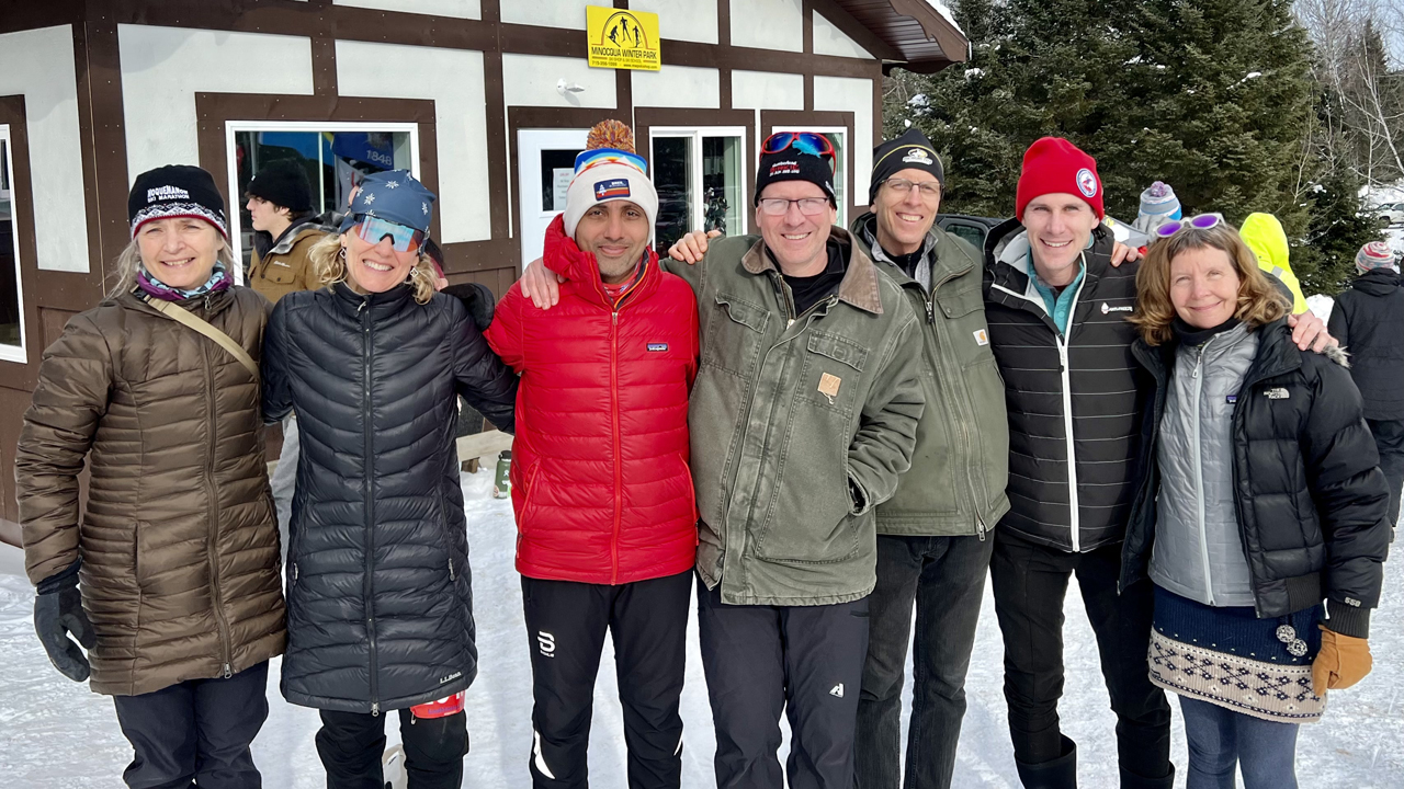 Seven people from the ski event in Wisconsin smiling at the camera