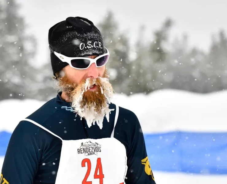 Candid photo of male participant in Yellowstone Rendezvous Race with snow caked in his beard