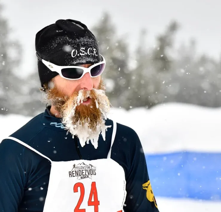 Candid photo of male participant in Yellowstone Rendezvous Race with snow caked in his beard
