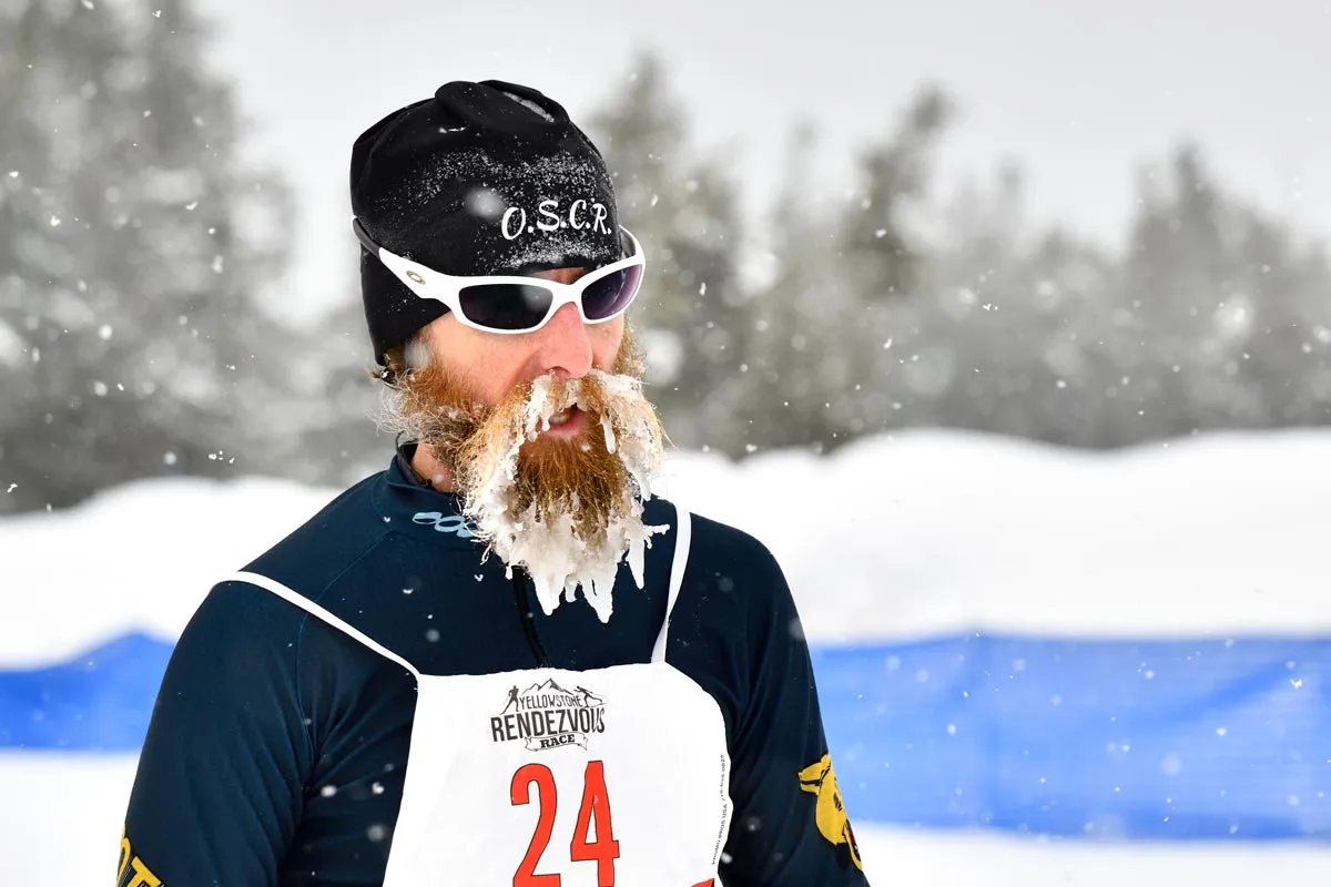 Candid photo of male participant in Yellowstone Rendezvous Race with snow caked in his beard